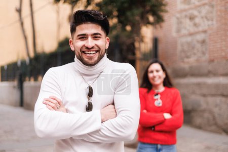 Portrait of a man in a white turtleneck sweater is standing next to a woman in a red sweater. High quality photo