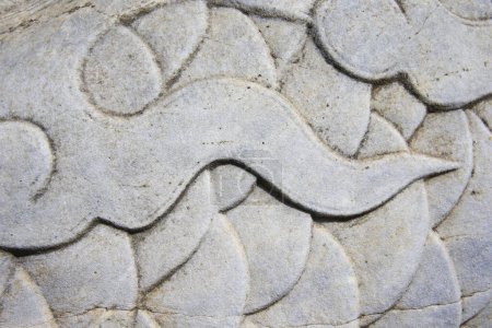 Vintage ornament on the stone. Close-up seamless texture. Stone texture. Pattern on the stone. Embossed pattern.