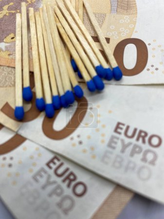 Photo for Close-up of matchsticks on 50 euro banknotes with selective focus on foreground - Royalty Free Image