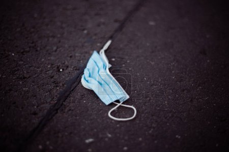 Photo for Lost protective medical mask on a street - Royalty Free Image