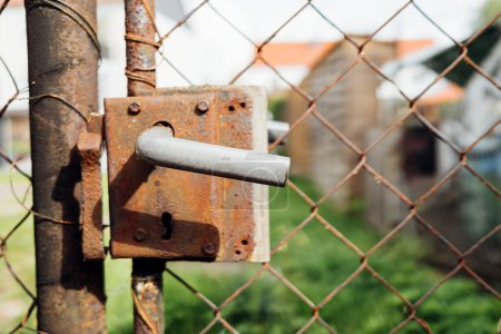 Photo for Rusty metal fence with handle, close up - Royalty Free Image