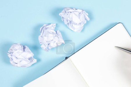 Photo for Crumpled paper and notepad on blue surface background - Royalty Free Image