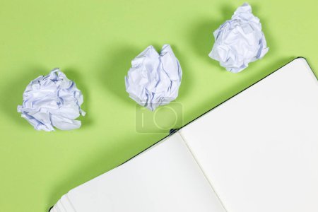 Photo for Crumpled paper and notepad on green  surface background - Royalty Free Image