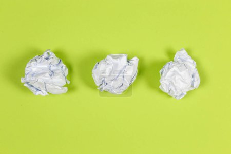 Photo for White crumpled paper balls on green background - Royalty Free Image