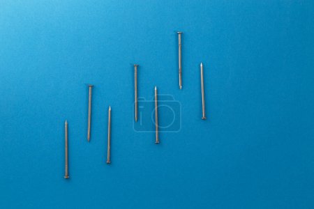 Photo for Nails isolated on blue background. - Royalty Free Image