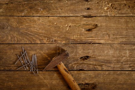 Photo for Nails and hammer on a wooden table - Royalty Free Image