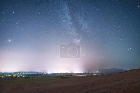 Photo for Scenic night view of rural field with sky full of stars - Royalty Free Image