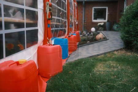 plastic containers of water in the garden.     