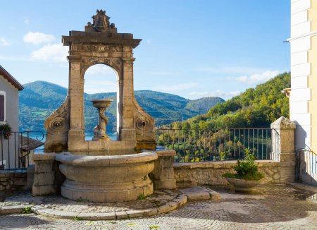 Photo for Fontana del Tritone in Castel di Tora with Lake Turano, beautiful village in the Province of Rieti. Lazio, Italy. - Royalty Free Image