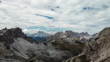 Photo for A panoramic view on Italian Dolomites. There are many high and sharp peak in front, with many landslides. Dangerous climbing. Barely any plants growing in the  area. Raw and unspoiled landscape. - Royalty Free Image