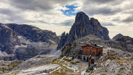 Photo for A panoramic view on the valley in Italian Dolomites. There is a big cottage in the middle. In the back there is a high mountain chain, with very sharp slopes. Serenity and recharging. - Royalty Free Image