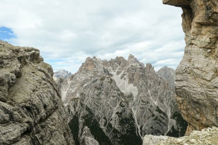 Photo for A distant view on a high mountain in Italian Dolomites. The Mountain is the highest in the region. It has very steep slopes, full of landslides and lose stones. High mountaineering. Experience - Royalty Free Image