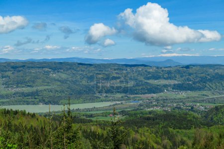 Photo for A panoramic view on Ferlacher Stausee, Austrian Alps. The river Drava is running through the valley. In the back the mountain chain Koralpe can be seen. Wanderlust - Royalty Free Image