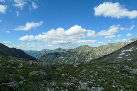 Photo for Panoramic view on huge glacier in Maltal region in Austrian Alps. The valley below it flourishing with green and freshness., small torrent in the middle. Summer in the mountains. Serenity and solitude - Royalty Free Image