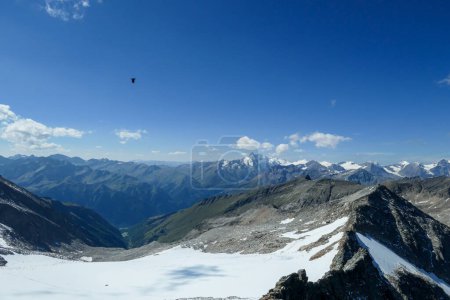 Photo for Panoramic view from top of Hohe Sonnblick in Austrian Alps on Grossglockner. The whole area is very steep and dangerous, with many lose stones. Many mountain chains in the back. Sunny day. Expedition - Royalty Free Image