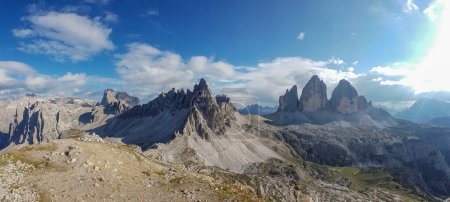 Téléchargez les photos : A panoramic capture of the famous Tre Cime di Lavaredo (Drei Zinnen) and surrounding mountains in Italian Dolomites. The mountains are surrounded by clouds. There is a lot of landslides. Serenity - en image libre de droit