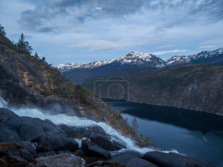 Photo for Middle parts of Langfossen waterfall at its splendid. Vast and tall waterfall, flowing around the rocks and in between the trees. Immense power of the nature. The water falls down a towering mountain - Royalty Free Image