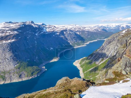 Foto de A panoramic view from above on a fjord-like Ringedalsvatnet lake, Norway . Snow-capped mountains. Spring slowly coming to the higher parts of the mountains. Water of the lake has a navy blue shade. - Imagen libre de derechos