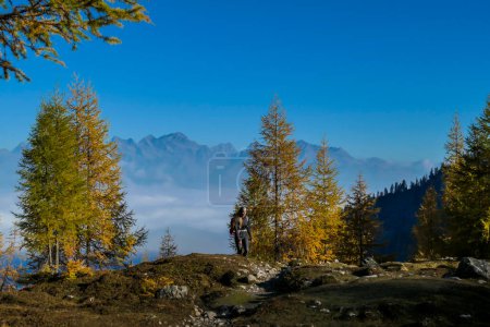 Photo for A woman with big hiking backpack walking through a stony pathway to reach the Grosse Gamswiesenspitze in Lienz Dolomites, Austria. Sharp and barren slopes. Massive Alpine mountains. Solo wanderer - Royalty Free Image