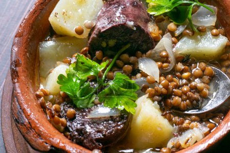 Food , Pot with boiled potatos , black sausage , onion , garlic , parsley