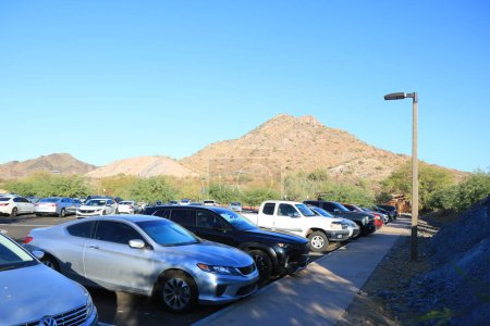 Photo for Phoenix, AZ - October 21, 2023: Early Saturday's morning tightly packed parking lot at entrance to family-friendly Phoenix Mountain Preserve also known as Dreamy Draw desert recreation area - Royalty Free Image
