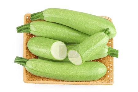 Photo for Zucchini or marrow in a wicker basket isolated on white background with full depth of field. Top view. Flat lay. - Royalty Free Image