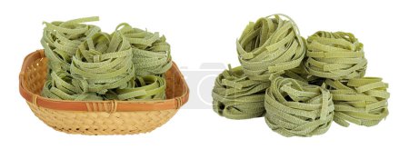 Raw tagliatelle green pasta with spinach in a wicker basket isolated on white background.