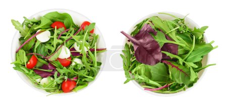 Mischen Sie Salat - Rucola, Spinat, Mangold, Kirschtomaten und Mozzarella in der Schüssel isoliert auf weißem Hintergrund. Ansicht von oben. Flache Lage.