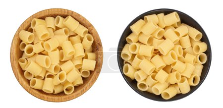raw italian pasta in wooden and ceramic bowl isolated on white background. Mezze Maniche Rigate Bronze die. Top view. Flat lay