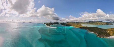 Panoramic, aerial photo of iconic Hill Inlet near Whitehaven beach on the Whitsundays, Queensland. Shot from above, gorgeous shades of aqua, blue and green mix from the silicone white sand and beach.