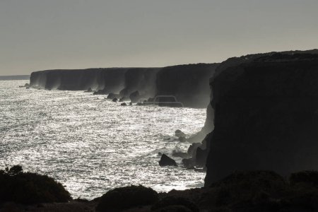 Moody and beautiful cinematic photo of the famous Bunda cliffs in the Nullarbor, silhouetted at sunset to create a monochromatic look, South Australia.