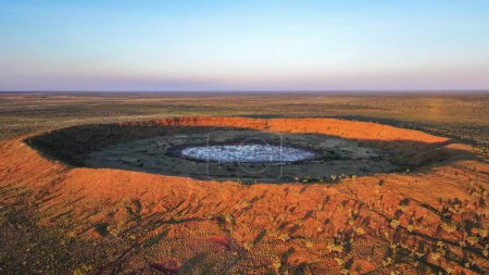 Drone photo at sunset above the second largest rimmed meteor impact crater in the world, based in remote Western Australia,