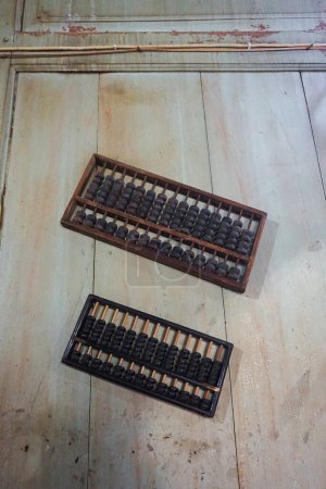 Two vintage abacus made out of wood on the table. Traditional method of counting and doing mathematics.