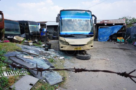 Photo for Lasem, Indonesia - August 9, 2018: Bus junkyard at Lasem, Rembang. Abandoned vehicle and unused car scrap parked in one area. - Royalty Free Image