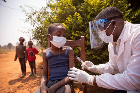 Sesión de vacunación al aire libre en una aldea africana durante la pandemia del virus de la corona.
