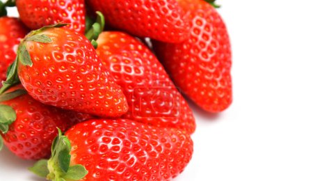 Bunch of red ripe strawberries, close-up macro photo, focus on the foreground.