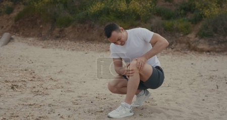 Téléchargez les photos : Concept de sport et de traumatisme - douleur au genou d'un sportif masculin - en image libre de droit