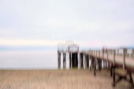 Photo for Intentional Camera Movement (ICM) image of Davis Bay Wharf and pebble beach on overcast day. Sechelt, BC - Royalty Free Image