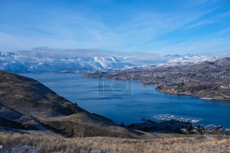 Looking over beautiful blue Lake Chelan, Washington in winter with snow covering distant mountains