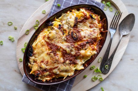 Oven baked cheese spaetzle with roasted onions. Traditional german food