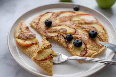 Delicious homemade oatmeal egg pancake with apples on a plate. Healthy breakfast for healthy eating, dieting or fitness
