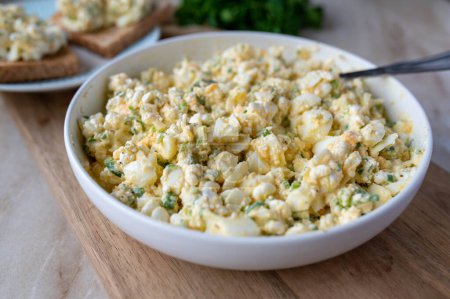 Low fat egg salad with cottage cheese, chives and olive oil without mayonnaise. Healthy protein rich  kitchen. Served ready to eat on a table.