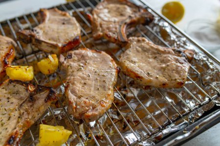 Oven grilled marinated pork chops on an oven rack