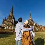 Back view of couple of tourist come to visit at Wat Phra Si Sanphet temple, Ayutthaya Thailand using maps for travel, vacation, holiday, honeymoon and tourism