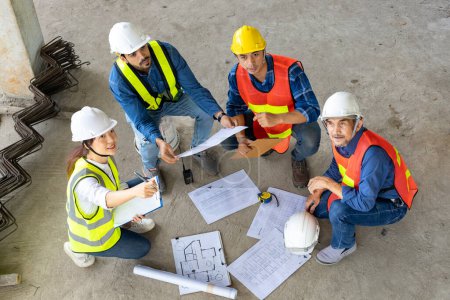 Photo for Top view of engineer, architect, contractor and foreman meeting at the construction building site with floor plan for real estate development project industry and housing inspection timeline usage - Royalty Free Image
