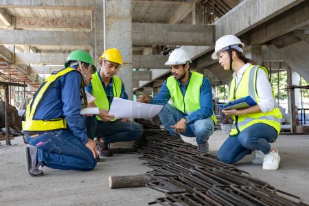 Team of engineer, architect, contractor and foreman meeting and consulting at construction building site with the floor plan for real estate development project industry and housing timeline