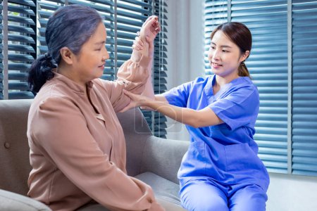 Photo for Asian physical therapist doctor is doing medical examination of elbow joint and bone of senior woman in the hospital for alternative healing approach for muscle and bone strength - Royalty Free Image