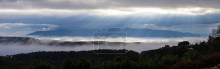 Photo for Panoramic shot of sun ray in the morning with fog flow through the mountain valley, Chiangmai, during rainy season Thailand - Royalty Free Image