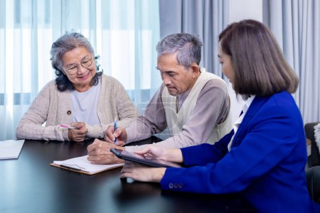 Photo for Asian senior couple is signing legal financial contract and insurance health care benefit for retirement home visit service by professional lawyer consultant - Royalty Free Image