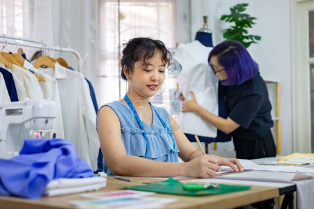 Photo for Fashionable freelance dressmaker is designing on new dress by drawing illustrator while working in artistic workshop studio for fashion design and clothing business industry concept - Royalty Free Image